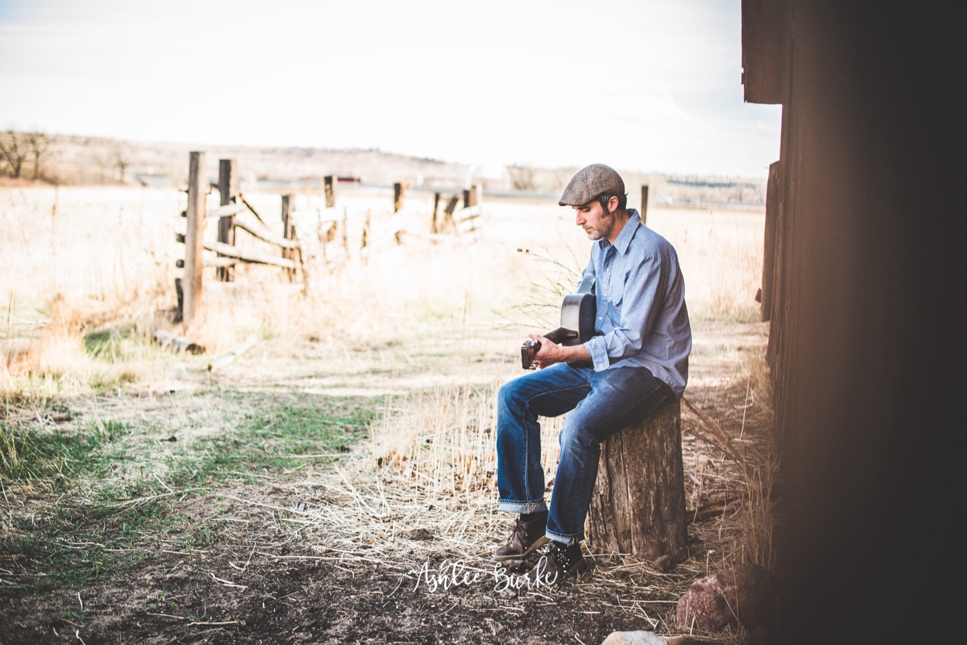 Steve Itterly playing guitar beside a barn